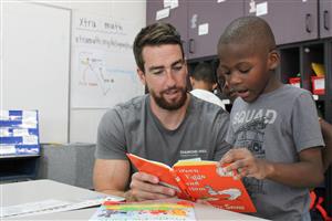 man reading to child